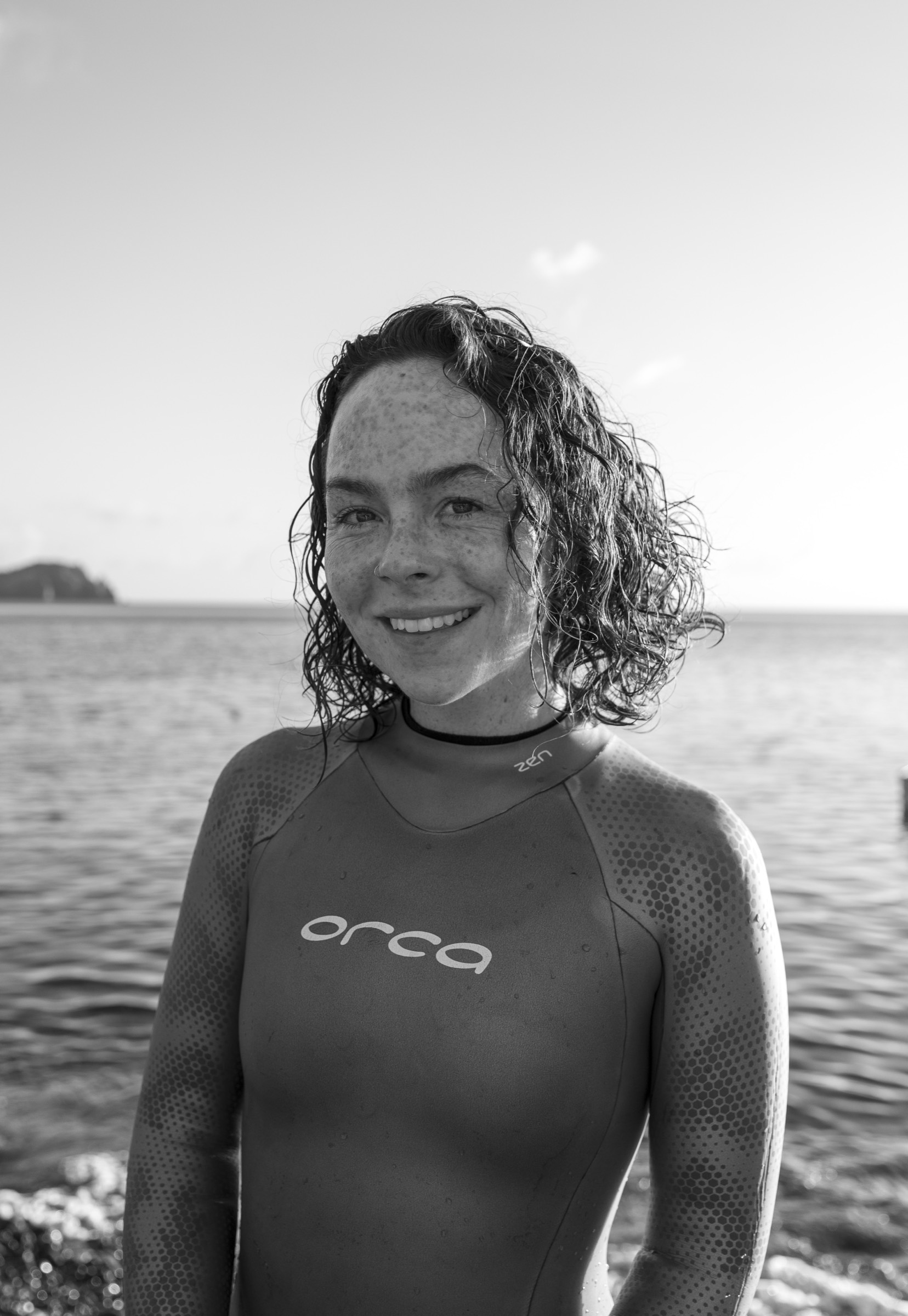 Black and white portrait of Natalie Bruce in an Orca wetsuit