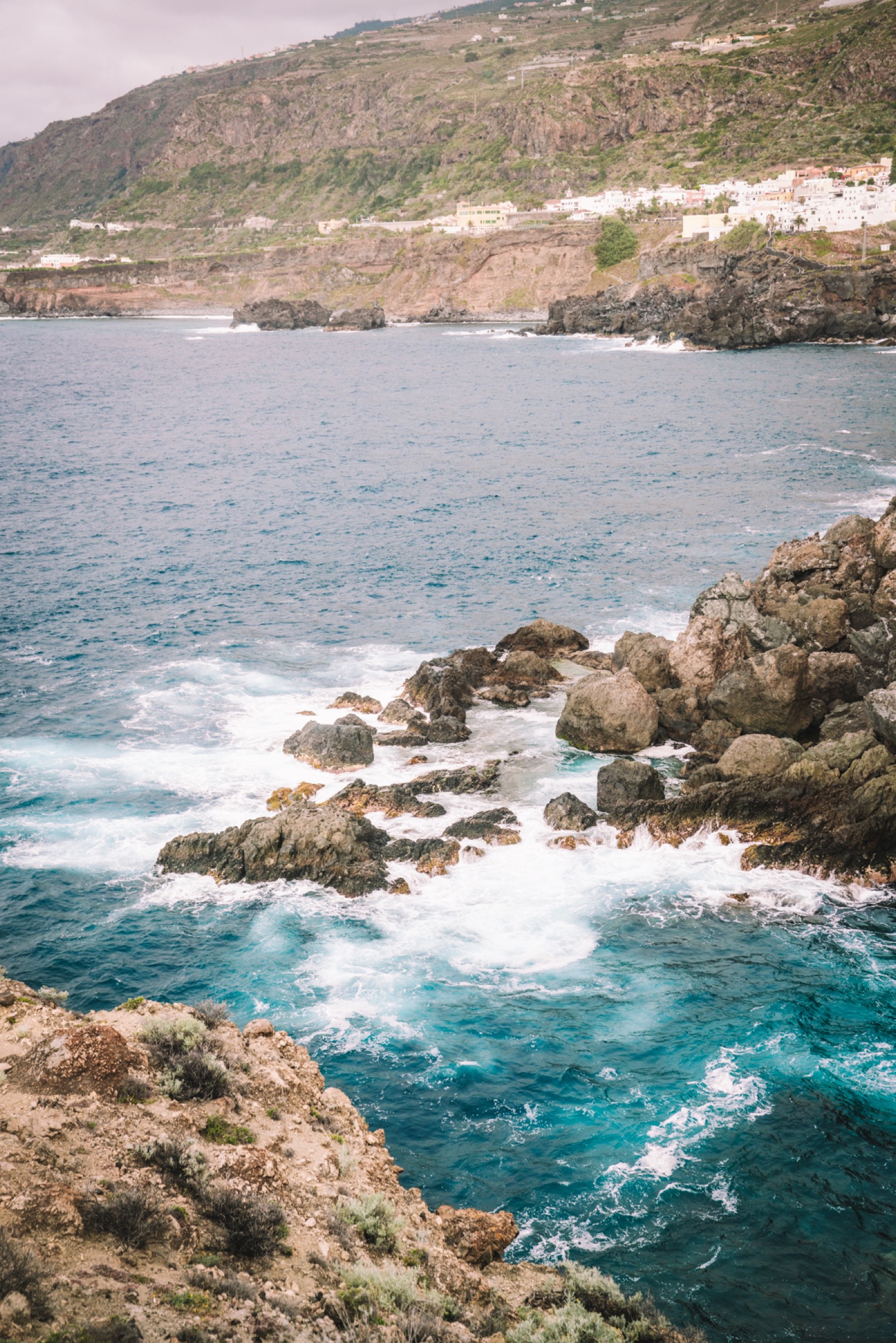 Volcanic coastline of Tenerife meeting the Atlantic Ocean