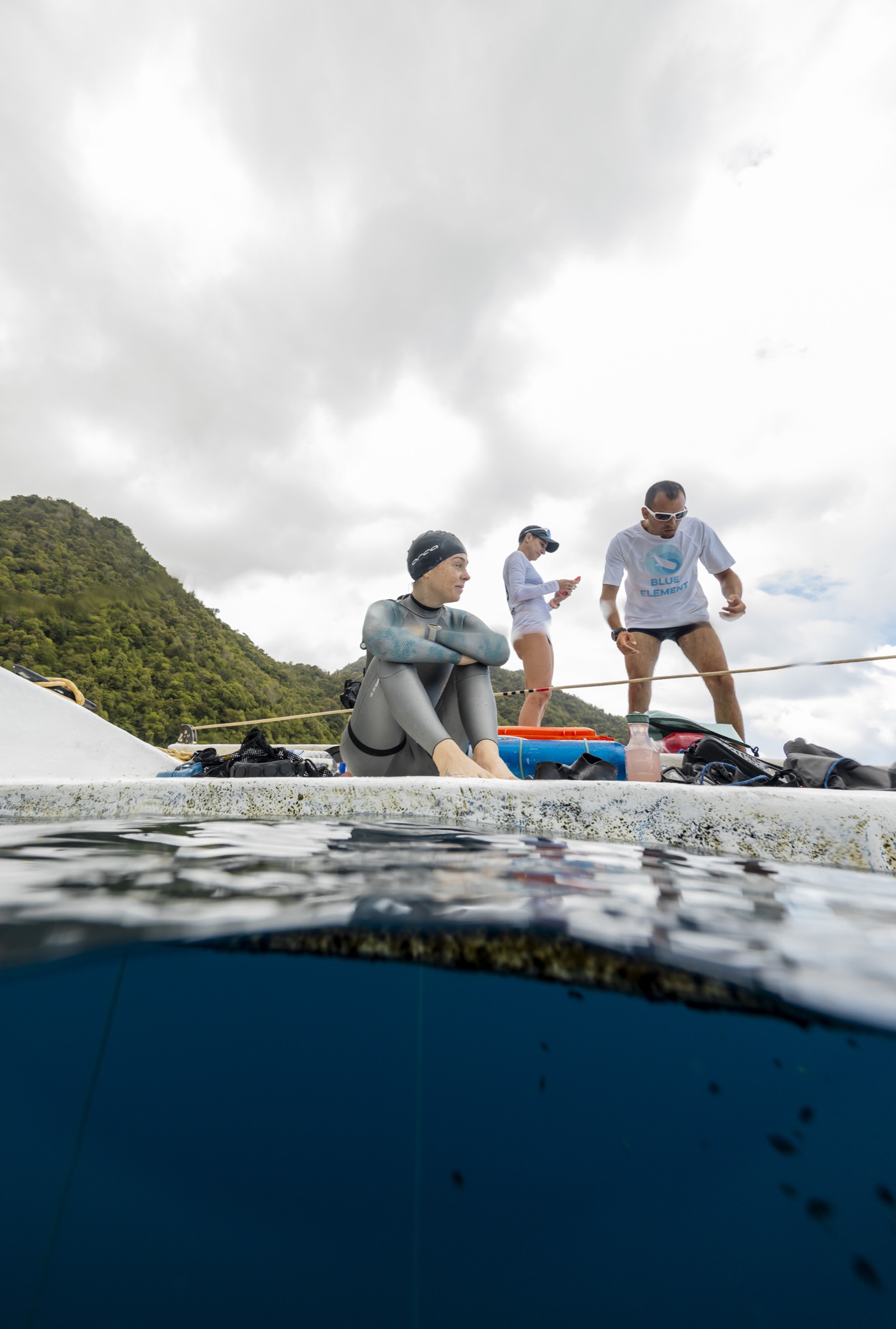 Natalie Bruce preparing with teammates on the boat before a dive