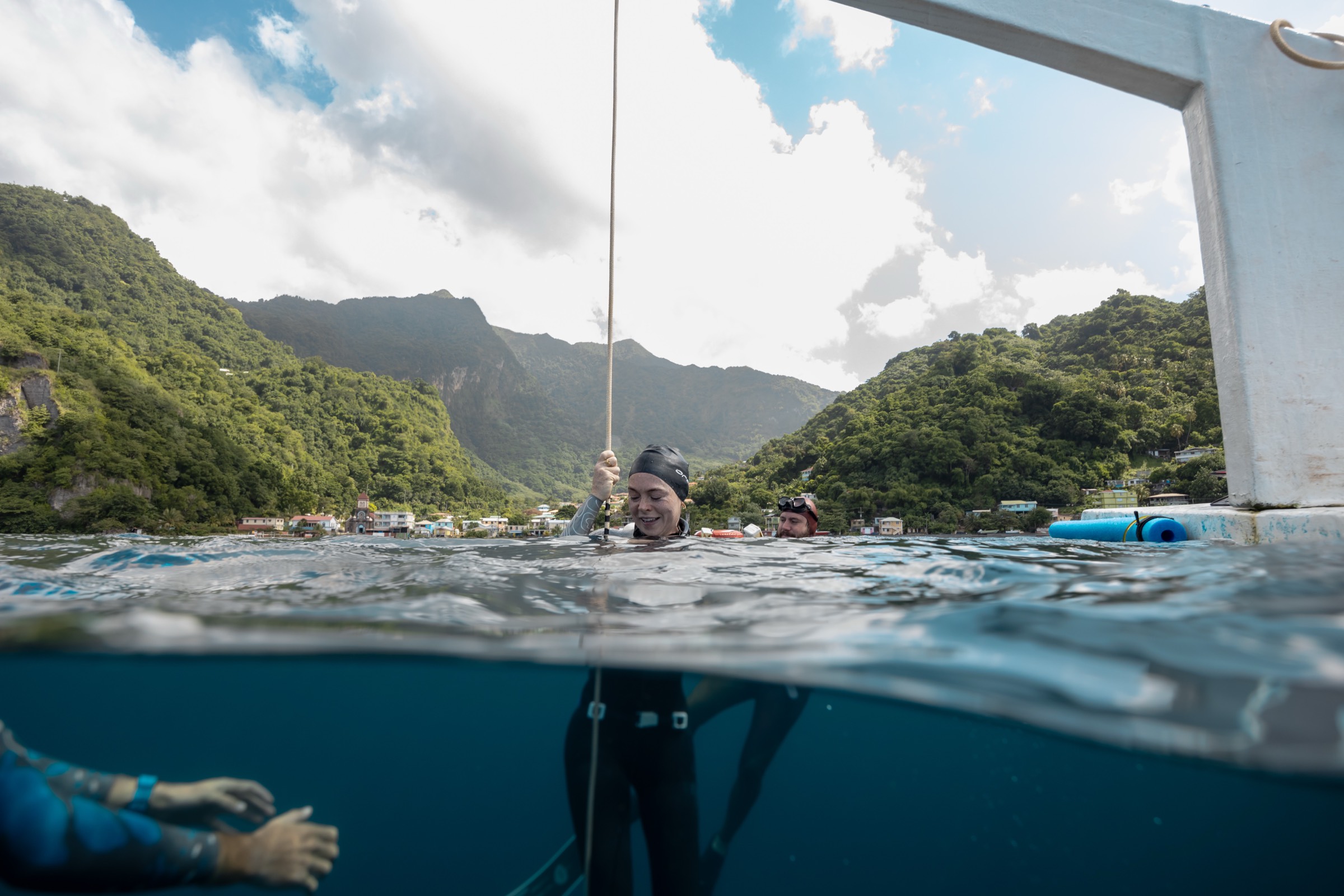 Natalie Bruce smiling at the surface after a dive with safety divers
